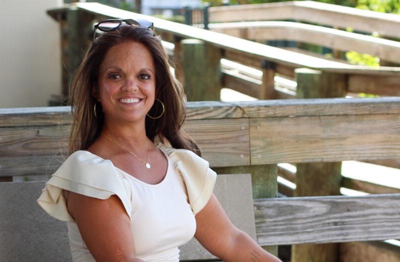 Kristen DeAndrade, sitting outside.